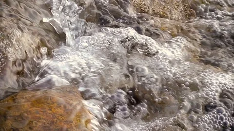Bubbles and flowing water in slow motion Stock-Footage 70738344
