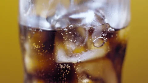Bubbles and ice in Cola, drops of water flowing down the glass Stock Footage 144175333