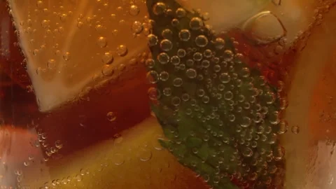 Bubbles and Ice Cubes in a Glass of Cola or Lemonade Stock Footage 246632476