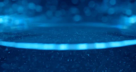 Bubbles and particles flowing in clear liquid under blue light Stock Footage 114087067