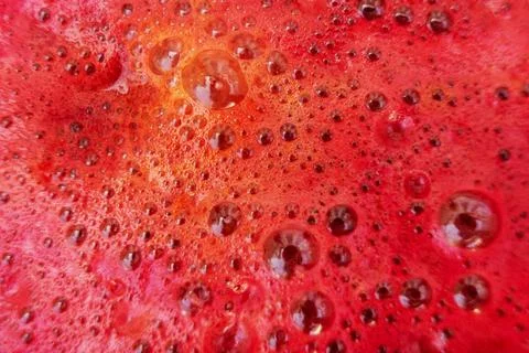 Bubbles on beetroot juice close-up, background, texture. Stock Photos