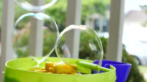 Bubbles being created from a bubble machine in slow motion close up Stock Footage 207337194