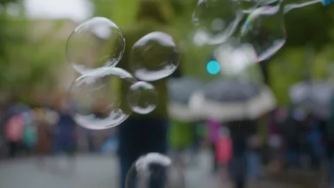 Bubbles blown through wand on street Stock Footage 87837783
