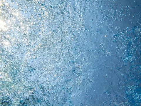 Bubbles in blue clear water Stock Photos