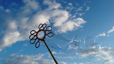 Bubbles with blue sky background with clouds Video stock 100940628