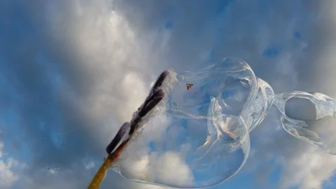 Bubbles with blue sky background with clouds Stock Footage 100941332