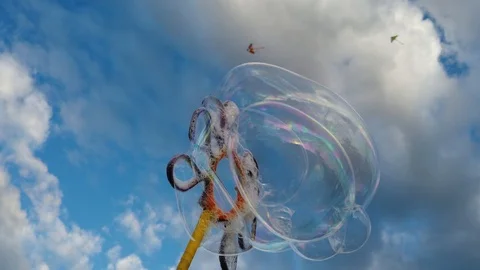 Bubbles with blue sky background with clouds Video stock 100941635