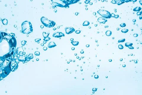 Bubbles in blue water background. Stock Photos