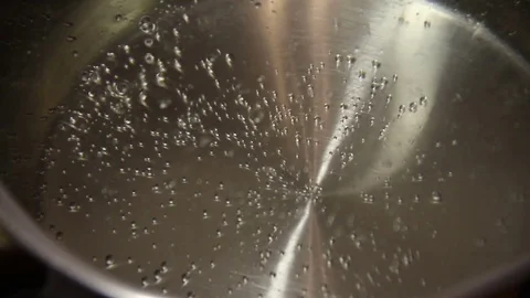 The bubbles of boiling water in a saucepan Stock Footage 83024507