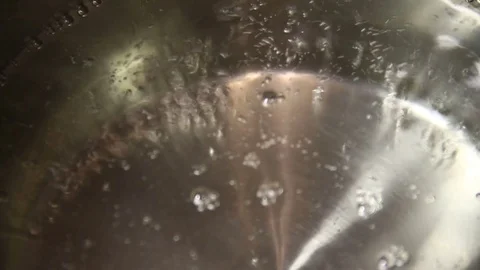 The bubbles of boiling water in a saucepan Stock Footage 83025023