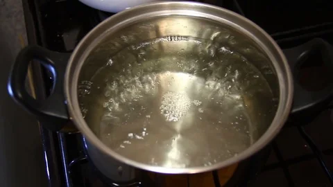 The bubbles of boiling water in a saucepan Stock Footage 83031178