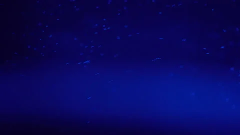Bubbles of boiling water in a teapot with blue light close up Stock Footage 144025470