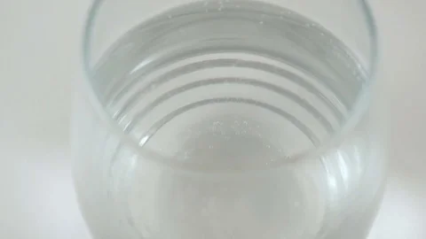 Bubbles Break on the Surface of a Glass of Tonic Water Stock Footage 74608689