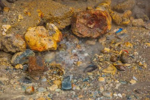 Bubbles bubbling in a puddle in the mountains with the volcano. Philippines,  Stock Photos