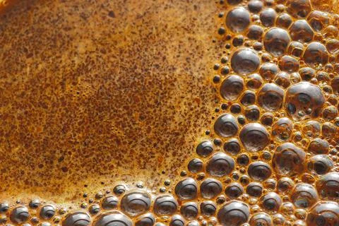 Bubbles of coffee foam close-up. Stock Photos