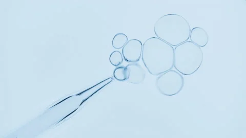 Bubbles come out from dropper and float on surface of liquid Video stock 167158775