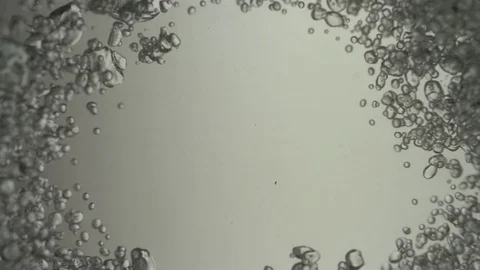 Bubbles Converge in on Grey Backdrop Stock Footage 75846195