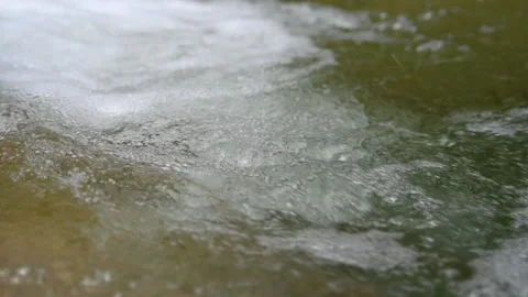 Bubbles created by a waterfall from a mountain stream (slow motion) Stock-Footage 219634767