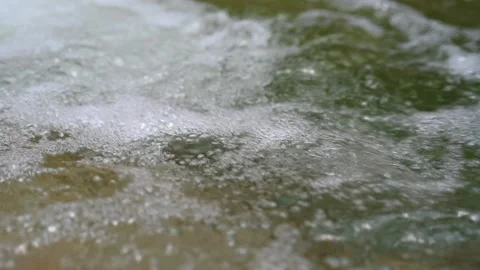 Bubbles created by a waterfall from a mountain stream (slow motion) Stock-Footage 219634954