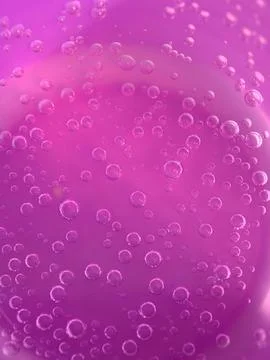 Bubbles dance in a vibrant pink background of sparkling wonder Stock Photos
