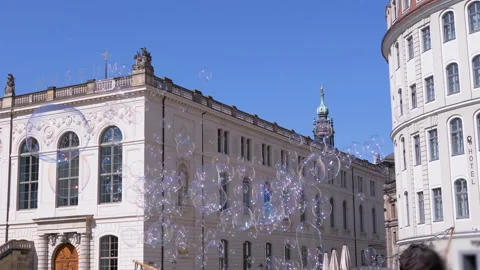 Bubbles Drift by City Buildings Stock Footage 312007437