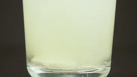 Bubbles from effervescent tablets in a glass slow motion Stock Footage 87796134