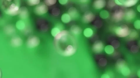 Bubbles explosion on blurred green background. Cosmetic advertising backgroun Stock Footage 306062756