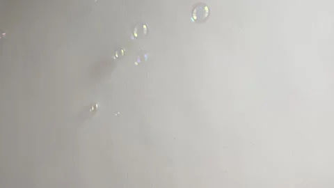 Bubbles fall and a finger bursts a bubble 4k Stock Footage 244636449
