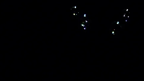 Bubbles falling against black background Stock Footage 82169425