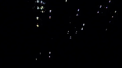 Bubbles falling against black background Stock Footage 82169750