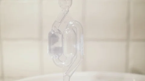 Bubbles in a fermentation lock Stock Footage 104314723