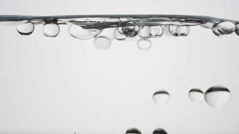 Bubbles float to the surface bouncing off it on grey background Video stock 230931488