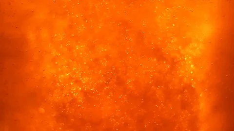 Bubbles floating in the amazing deep structured orange liquid. Video stock 79834519