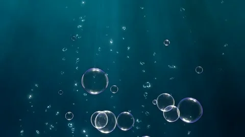 Bubbles floating in dark blue water Stockbeeldmateriaal 335532496