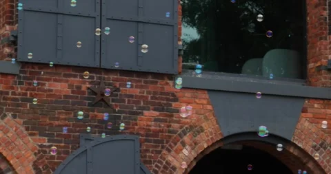 Bubbles Floating in Front of Brick Building in New York, July 2023 USA Stock Footage 307446540