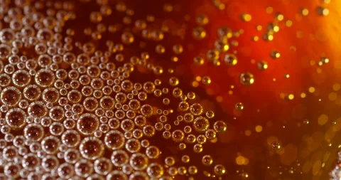 Bubbles floating on a liquid surface. Abstract close up shot of beer, cider or Stock Footage 146602409