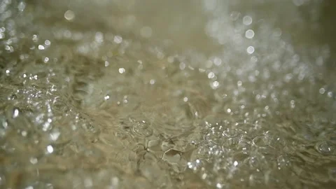 Bubbles flow on the water of a mountain stream (slow motion, bokeh) Stock-Footage 219640227