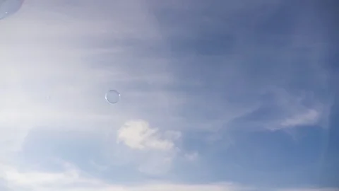 Bubbles flying through the sky, slow motion Stock Footage 74630360