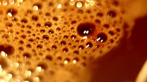 Bubbles with foam with bokeh effect on surface of hot cocoa are stirred. Stock Footage 205914306