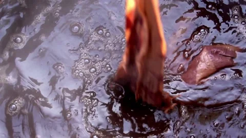 Bubbles Form On Water Surface During Dyeing Textiles With Organic Red Stock Footage 156009817