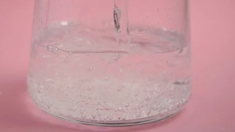 Bubbles forming in water on pink background Stock Footage 342691069