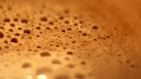 Bubbles with froth on surface of hot cocoa being stirred close-up Stock Footage 206312175