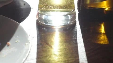 Bubbles in glass of beer facing the sun Stock Footage 253225261
