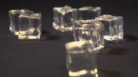 Bubbles on glass with ice cubes in sparkling water in rotation on black Stock Footage 104672415