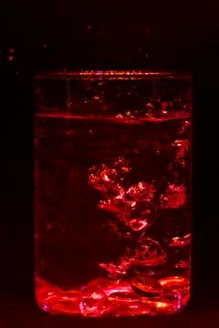 Bubbles in Glass in Red Light Stock Photos