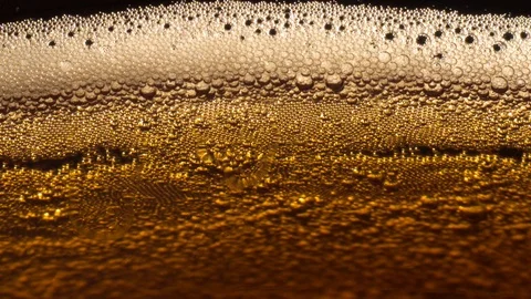 Bubbles in a golden drink Stock Footage 119370349