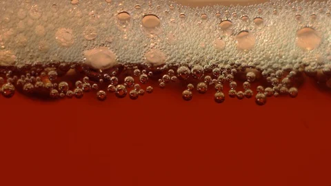 Bubbles in a golden drink Stock Footage 119370408
