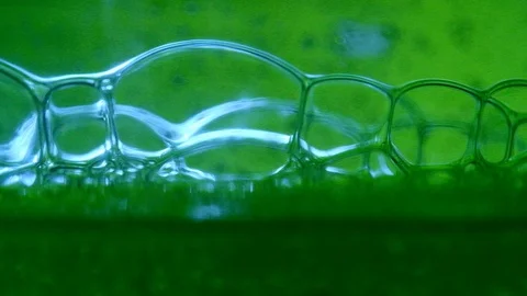 Bubbles on green slow motion Stock Footage 128237667