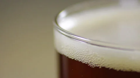 The bubbles in the head of a beer in a glass, extreme close up Stock Footage 61960180