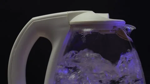 Bubbles in hot water boiling inside glass teapot Stock Footage 264584581